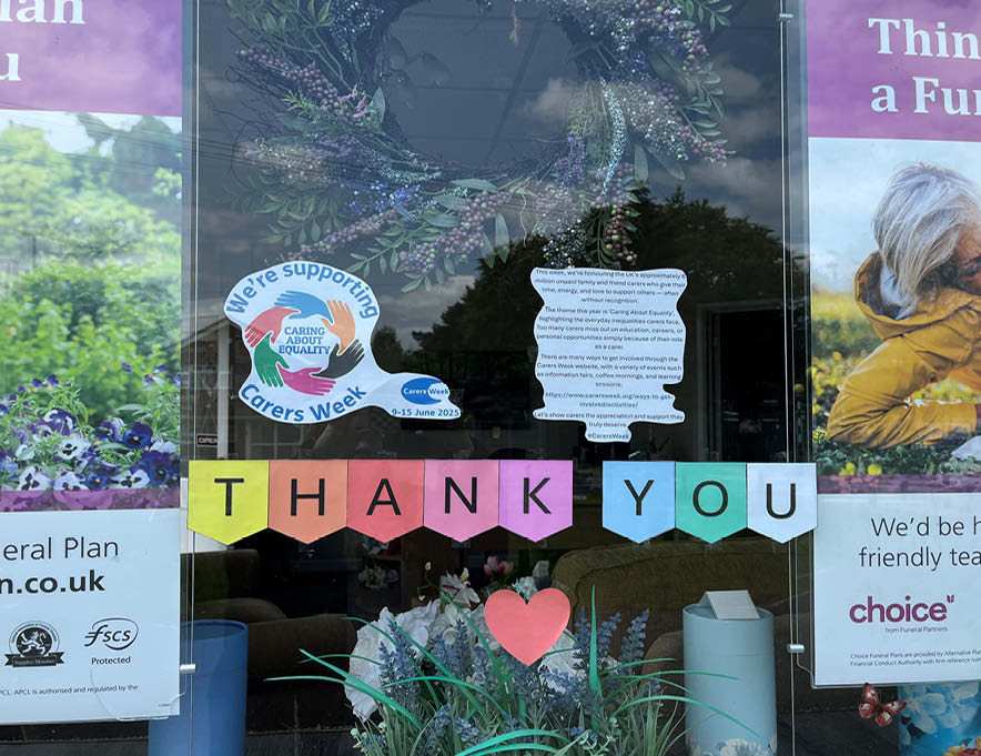 A decorated branch window adorned with carers week signage.